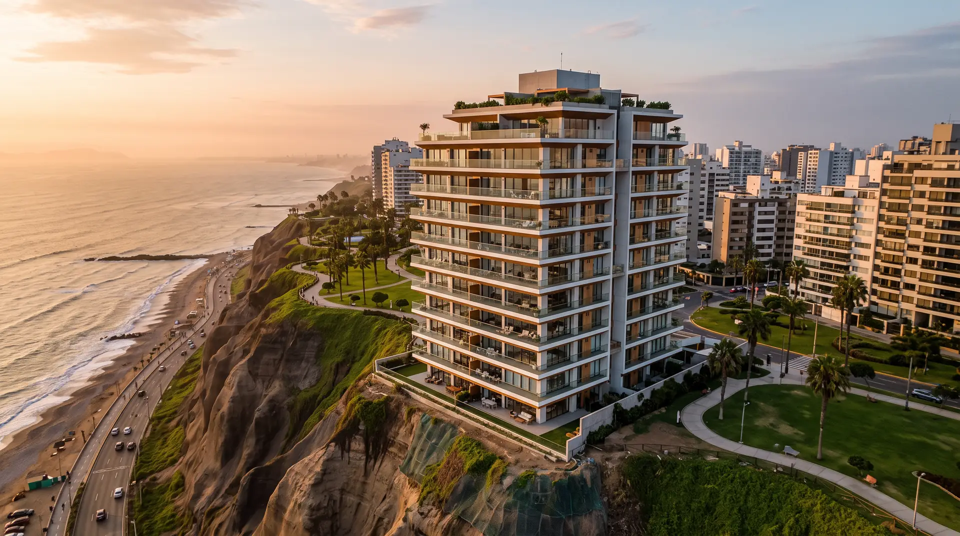 Vista aérea de Torre Malecón, edificio blanco de 12 pisos al borde del acantilado de la Costa Verde